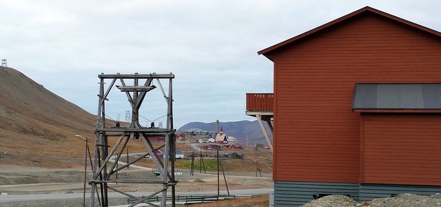 Old frames from the mining cable system near colorful Longyearbyen housing. 