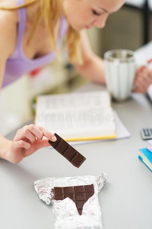 girl-eating-chocolate-studying-kitchen-closeup-teenager-32744998.jpg