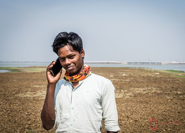 Rural boy talking on smartphone - 5G not coming soon to these areas