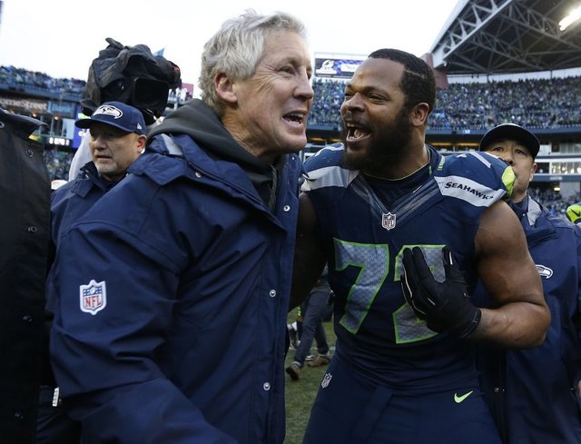 Seahawks head coach Pete Carroll with defensive end Michael Bennett