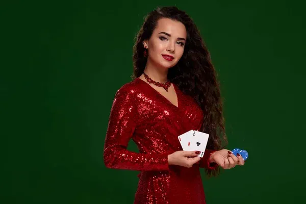 Beautiful curly woman in a glittered dress, holding some playing cards and gambling chips. Casino — Stock Photo, Image