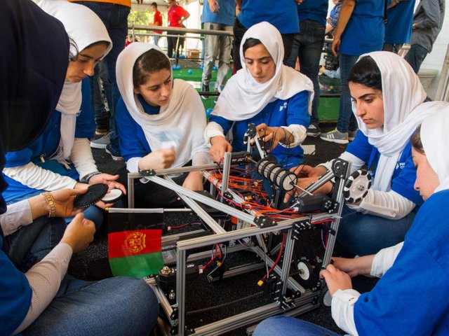 Members of the Afghan all-girls robotics team make adjustments to the team robot in the practice area on July 17, 2017 - Paul J. Richards/AFP/Getty Images
