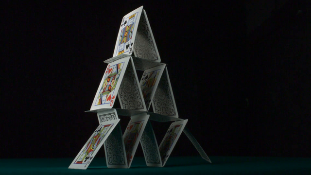 pyramid-house-of-playing-cards-falling-down-slow-motion_nyw3tndeg__F0000.png