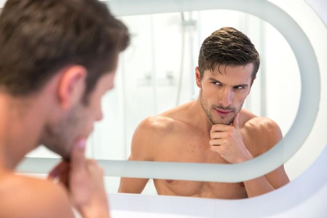 Man-looking-at-his-reflection-in-the-mirror.jpg