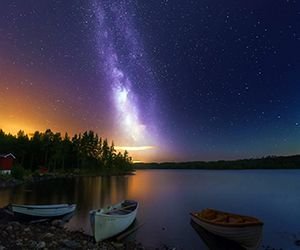 Peaceful-lake-boats-wooden-house-forest-sky-with-stars-night-1920x1080.jpg