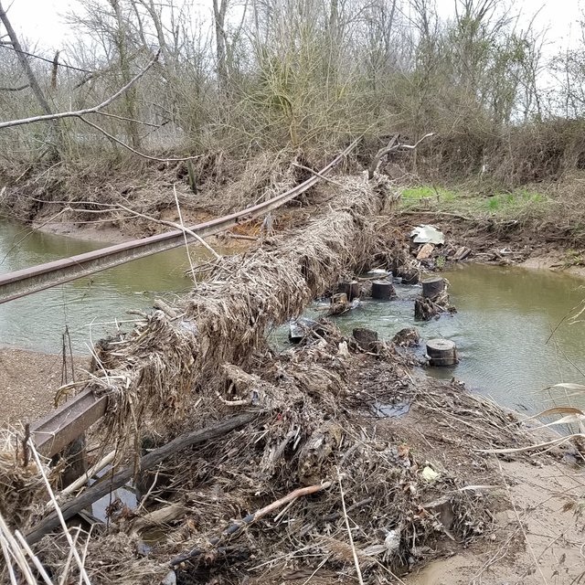 Abandoned railroad tracks hanging over creek