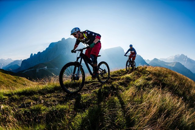 a-pair-of-mountain-bikers-riding-in-the-dolomites-range-in-north-eastern-italy.jpg
