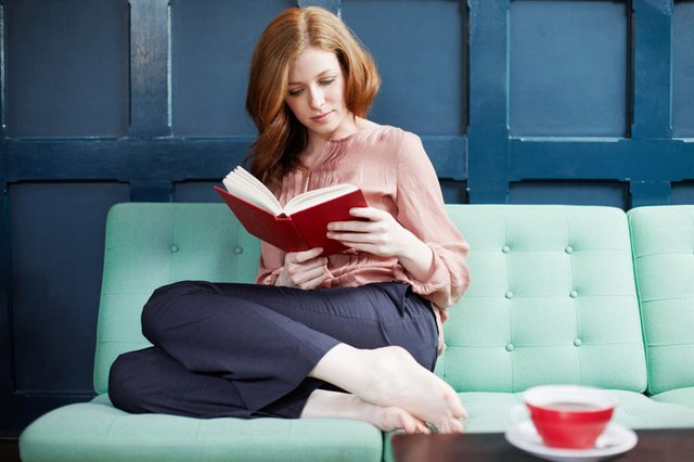 Woman-reading-a-book-on-sofa.jpg