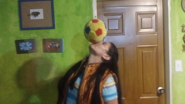 Ledis manages to balance a ball on her face for one frame.jpg