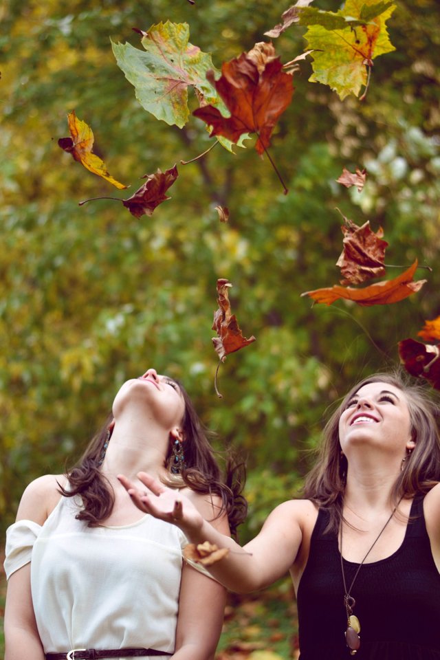 Two Girls throwing leaves into the Air.jpg