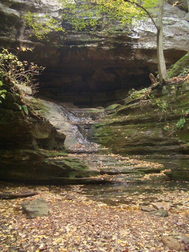 Water puddling at the base of a sandstone cliff