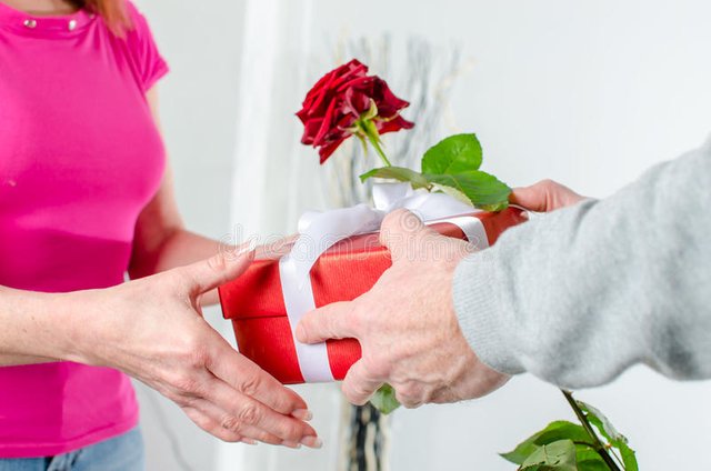 man-giving-rose-gift-to-woman-women-valentine-s-day-49456848.jpg