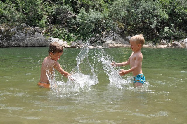 two-boys-playing-water-10306864.jpg