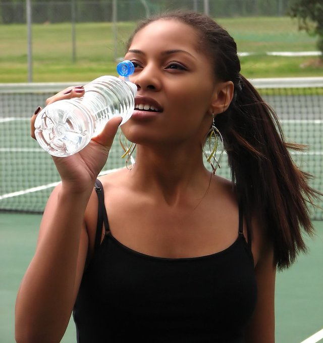 5176-a-beautiful-teen-african-american-girl-drinking-water-on-a-tennis-court-pv.jpg