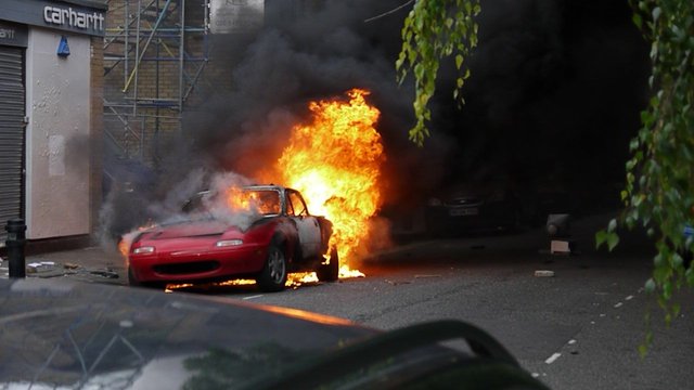 8732989014 - mazda mx5 burning outside the recently looted.jpg