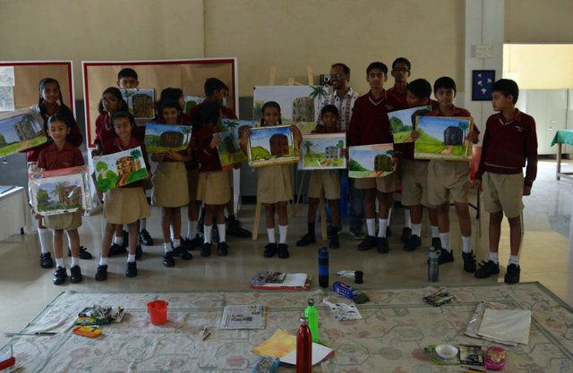 Workshop Participants with their paintings on the first day