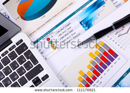 stock-photo-financial-paper-charts-and-graphs-on-the-table-111176621.jpg