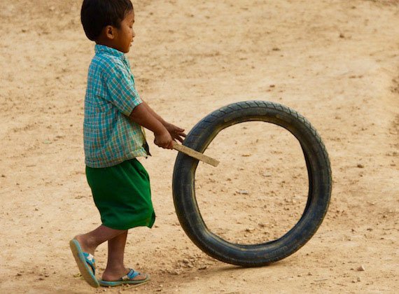 boy-playing-with-old-tire.jpg