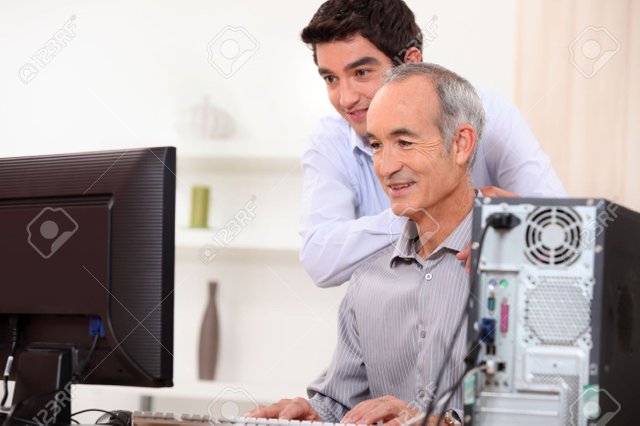 14211789-Young-man-teaching-an-elderly-man-computer-skills-Stock-Photo-computer-old-people.jpg