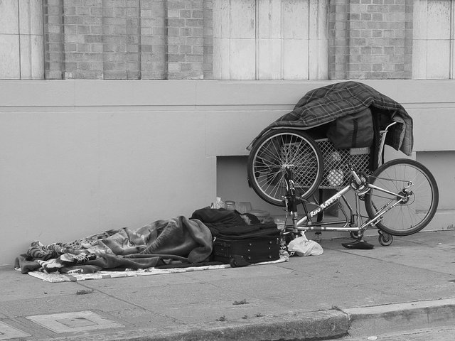 homeless_reading_on_the_sidewalk.jpg