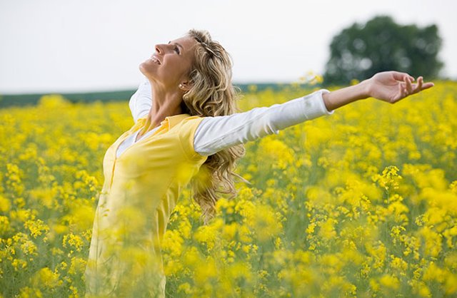 Joyful-Optimistic-Woman-in-Yellow-Field.jpg