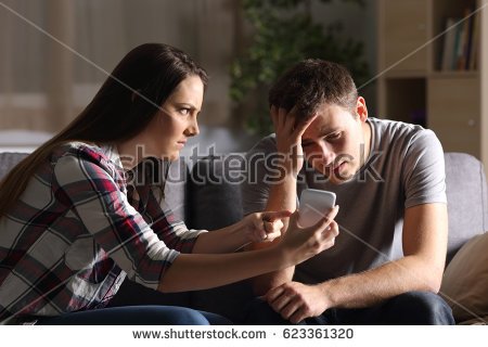 stock-photo-girlfriend-asking-for-explanation-of-her-boyfriend-sitting-on-a-couch-in-the-living-room-in-a-house-623361320.jpg