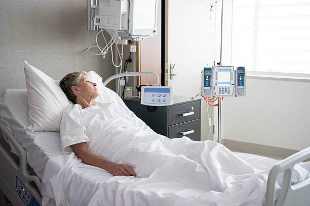 senior-woman-lying-in-hospital-bed-looking-away-picture-id532054688.jpg