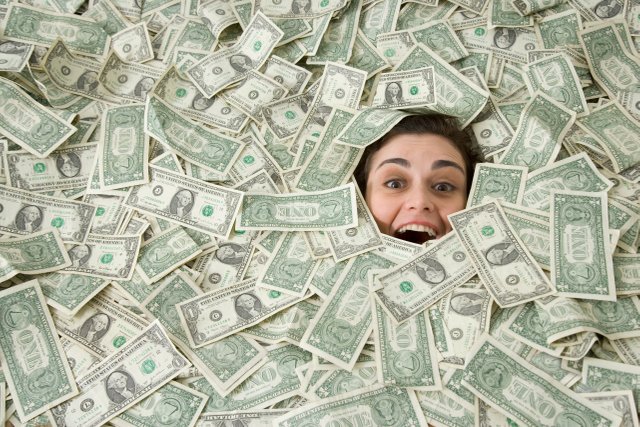 woman-s-face-peeking-out-of-a-pile-of-money-71418271-57d6590e5f9b589b0ad652aa.jpg