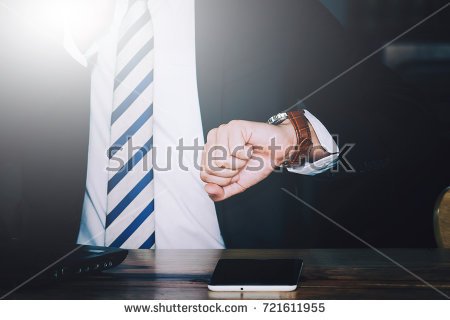 stock-photo-busy-businessman-looking-at-wristwatch-in-business-time-is-important-men-wear-a-suit-arms-up-721611955.jpg