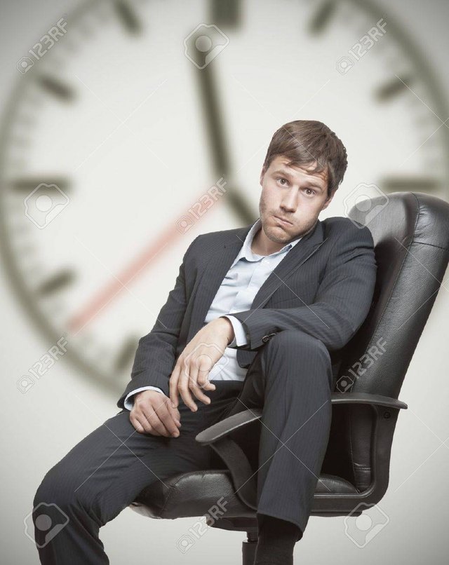 14433306-frustrated-young-business-man-waiting-for-the-end-of-the-workday.jpg