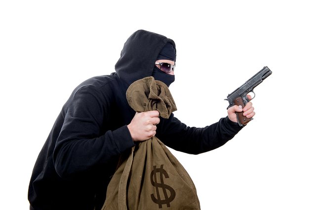 bigstock-Hooded-Robber-With-A-Gun-And-A-78546158.jpg