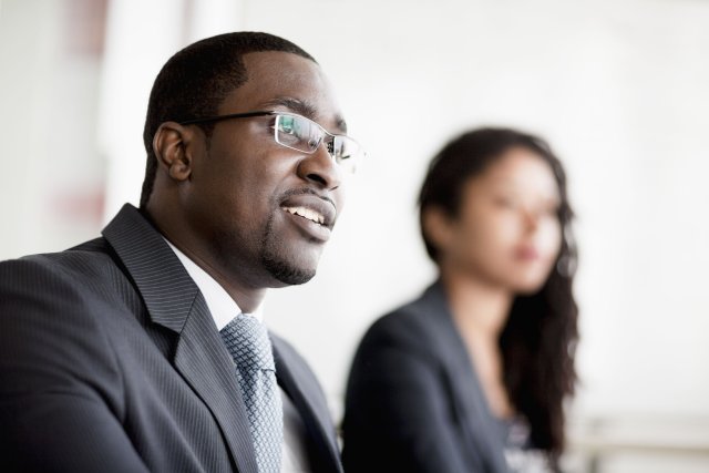 smiling-businessman-listening-at-a-business-PJW9URS.jpg