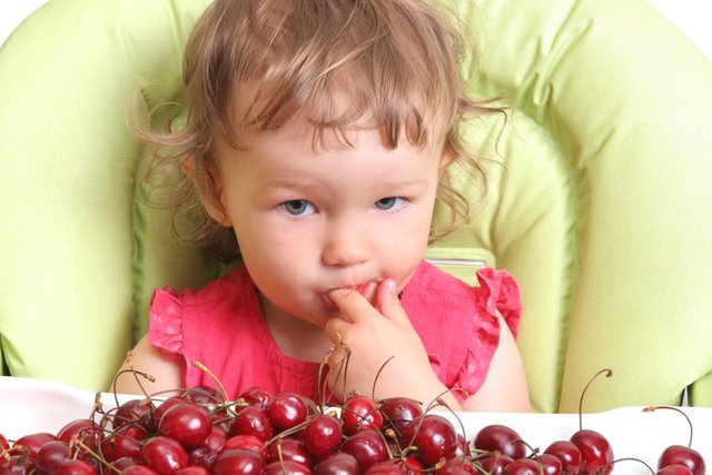 child-tastes-cherry-10062357.jpg