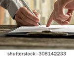 stock-photo-closeup-of-businessman-showing-his-new-business-partner-where-to-sign-an-agreement-or-contract-with-308142233.jpg