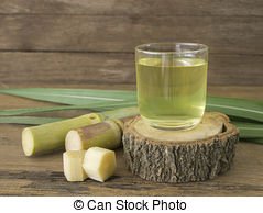 freshly-squeezed-sugar-cane-juice-in-glass-with-cut-pieces-cane-on-a-wooden-table-picture_csp31613173.jpg