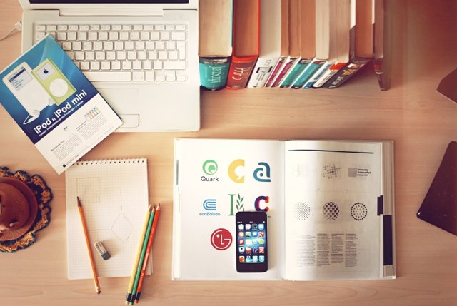 aerial-view-of-laptoop-books-mobile-phone-and-books-on-wooden-table.jpg