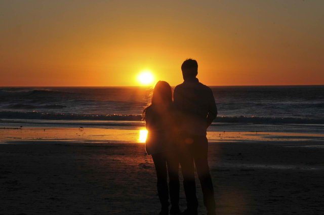 lovers-enjoying-ocean-sunset.jpg