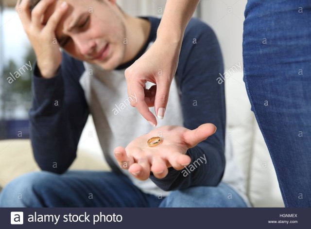 closeup-of-a-wife-breaking-up-relationship-leaving-the-wedding-ring-HGNMEX.jpg