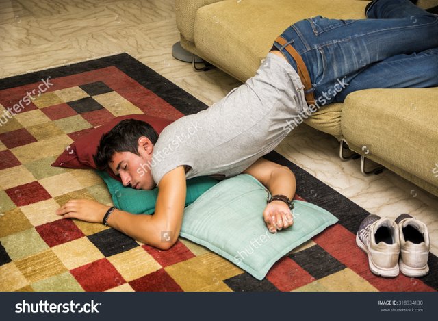 stock-photo-drunk-young-handsome-man-resting-on-couch-in-the-living-room-with-head-on-the-floor-318334130.jpg