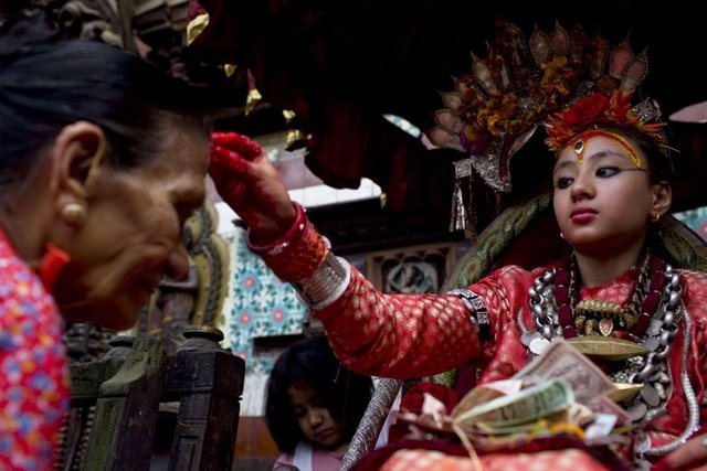 Kumari-Places-Tika-red-powder-on-the-forehead-of-an-elderly-woman-1024x683.jpg