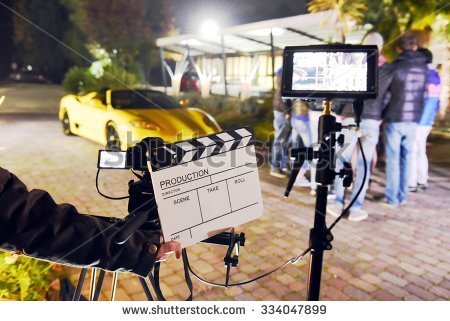 stock-photo-operator-holding-clapperboard-during-the-production-of-short-film-outdoor-in-the-night-with-334047899.jpg