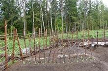 spring garden with hills and rustic fencing