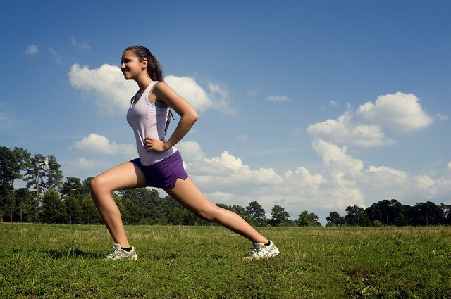 15250-a-young-woman-stretching-outdoors-before-exercising-pv.jpg