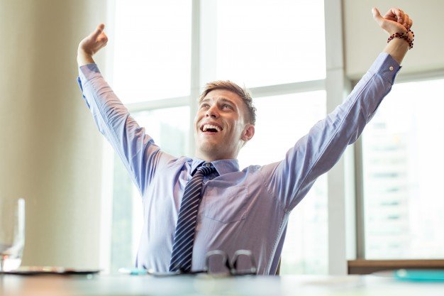 joyful-business-man-raising-arms-at-office-desk_1262-3790.jpg