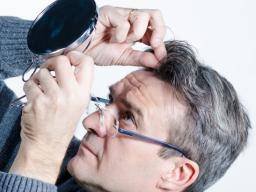 man-checking-his-hair-in-mirror.jpg