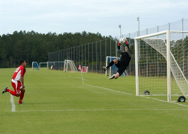 US_Navy_070119-N-6645H-001_The_All-Navy_men's_soccer_team_starting_goalkeeper,_Mass_Communication_Specialist_3rd_Class_Ian_Elias,_goes_up_for_a_save_during_a_match_against_the_Marines_held_at_Patton_Park.jpg