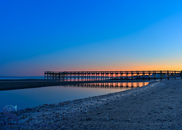 Walnut Beach pier at Low tide and sunrise.jpg