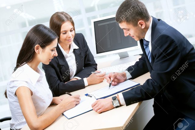 12510319-business-people-working-together-in-office-Stock-Photo.jpg
