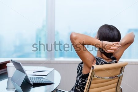 stock-photo-business-woman-relaxing-working-at-office-desk-laid-back-resting-on-chair-with-hands-behind-head-492639292.jpg