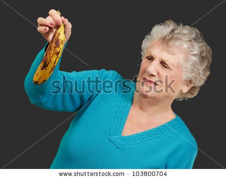 stock-photo-senior-woman-holding-a-rotten-banana-over-a-black-background-103800704.jpg